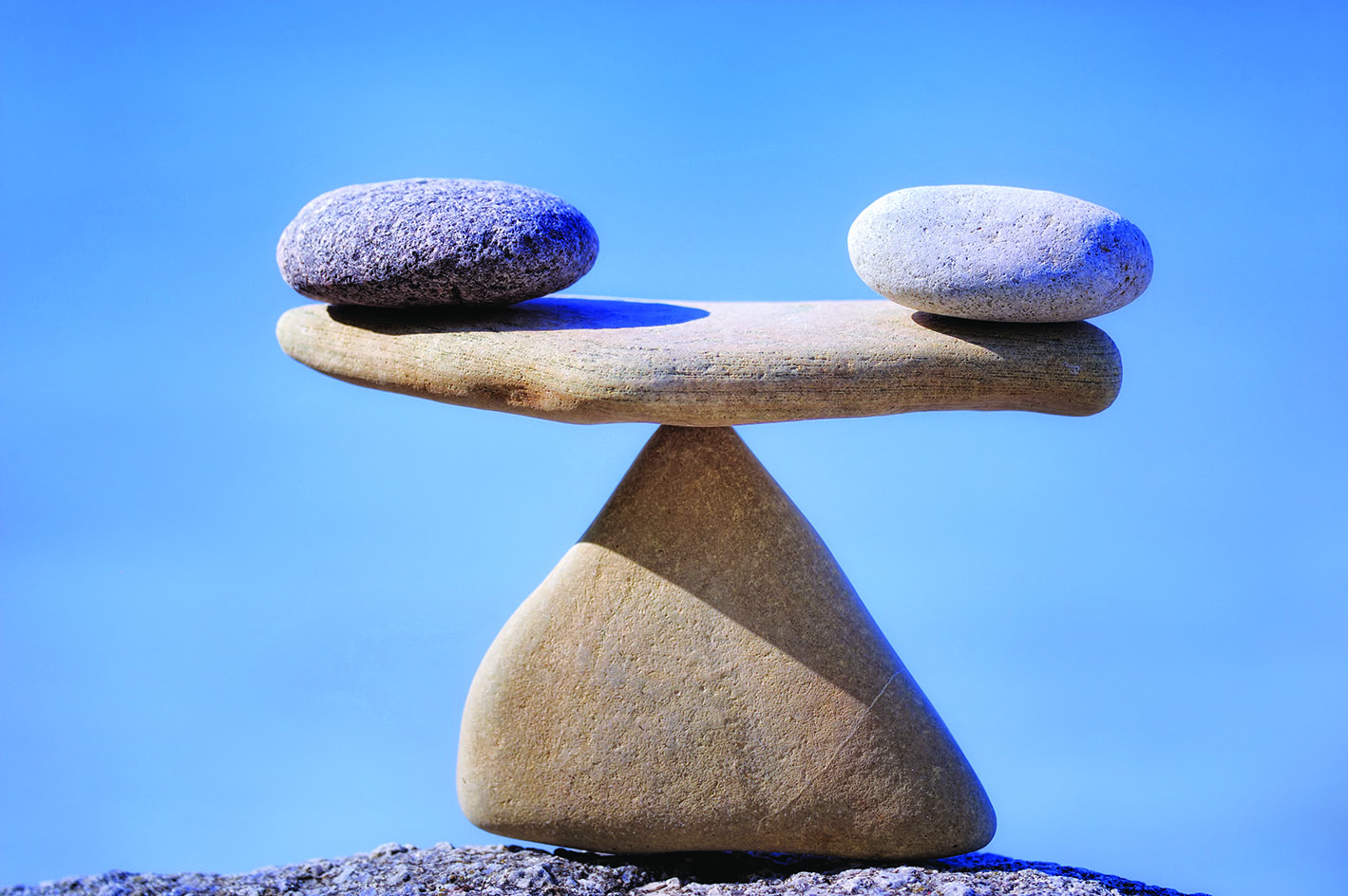 Pair of scales is made of stones on the cliff